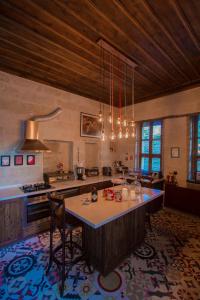 a large kitchen with a large island in the middle at Asuwari Suites Cappadocia in Ürgüp +49 photos