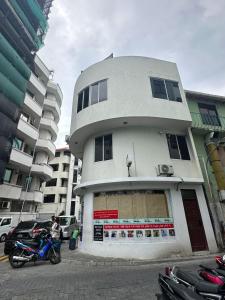 a building with a motorcycle parked in front of it at Resting View One Bedroom Apartment in Male City