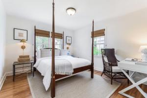 a bedroom with a canopy bed and a desk at Stay at Black Rock Harbor in Bridgeport
