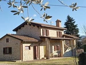an external view of a stone house with a patio at Casa Paradiso - Assisi in Assisi