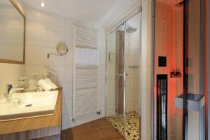 a bathroom with a sink and a shower at Jungmann Apartments in Ischgl