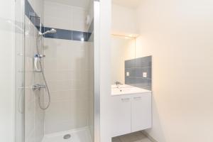 a white bathroom with a shower and a sink at Super appartement, la Guérinière à Noirmoutier in La Guérinière +18 photos