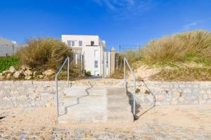 a set of stairs leading up to a building at Super appartement, la Guérinière à Noirmoutier in La Guérinière