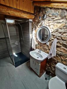 a stone bathroom with a sink and a mirror at Casa Pradillo in Añavieja +37 photos
