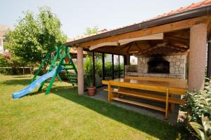 a gazebo with a slide and a playground at Apartments Mia in Baška