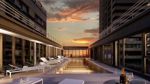 a view of a building with chairs and a sunset at Recoleta Grand, Buenos Aires, a Tribute Portfolio Hotel in Buenos Aires