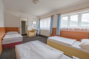 Ένα ή περισσότερα κρεβάτια σε δωμάτιο στο Sport Hotel Gejzirpark