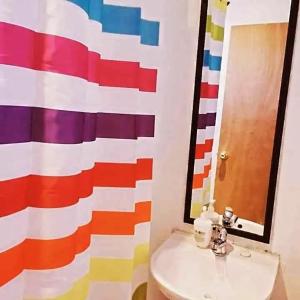 a bathroom with a sink and a colorful wall at Desert Wings in San Pedro de Atacama +33 photos