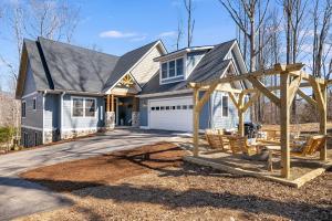 a house with a playground in front of it at Secluded 5BR Stay,HotTub,Sauna,GameRoom,FirePit in Hendersonville