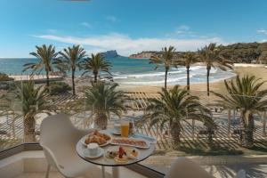 a breakfast table with a view of the beach at La Sort Boutique Hotel in Moraira