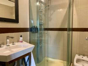 a bathroom with a sink and a glass shower at Joseva 302 in Río Gallegos
