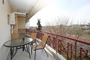 a balcony with a table and chairs and a view at #Ioanna Apartments Unique in Thessaloniki