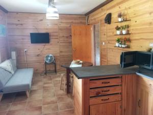 a kitchen with a counter and a couch in a room at El guajiro in Mas de las Matas