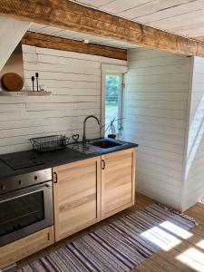 a kitchen with a sink and a stove at Humlesten's Gård in Huaröd
