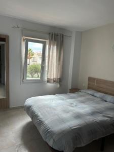 a bedroom with a large bed and a window at Edificio Acapulco in Nerja