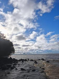 a view of the ocean with a cloudy sky at Luz de Maria in Belém +15 photos