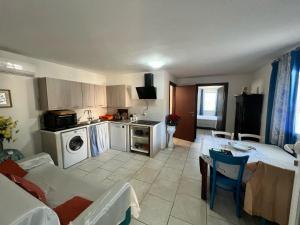 a kitchen with a table and a kitchen with a stove at Villa dei Venti in Ostuni