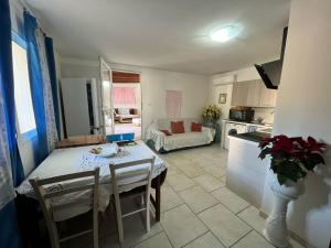 a kitchen and a living room with a table and chairs at Villa dei Venti in Ostuni +7 photos