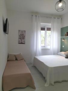 Postel nebo postele na pokoji v ubytování Lugore Room + 35 fotografií