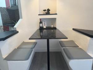 a table with chairs and a bottle of wine at Paraiso Sur & Panoramic Views Apartment, Tenerife in Adeje