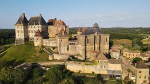 an old castle on top of a hill at chalet Vital avec Spa privatif in Biron