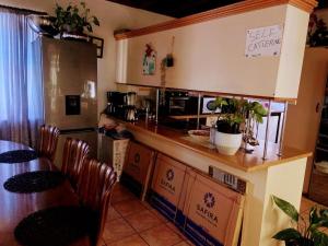 a kitchen with a counter and a table with chairs at Zagorski bed and breakfast its homestay home away from home in Cape Town
