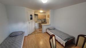 a small room with two beds and a kitchen at Rozalia in Wisełka
