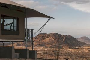 a person sitting in a tv in the desert at Camp Elena - Luxury Tents Minutes from Big Bend and Restaurants in Terlingua