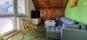 a living room with a couch and a table at Domek v Moravském Krasu in Lipovec