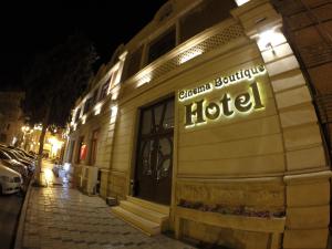 a hotel sign on the side of a building at night at Cinema Boutique Hotel in Ganja