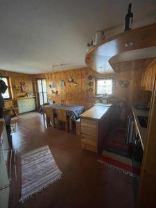 a kitchen with a table and a dining room at Bormio and Livigno house in Isolaccia