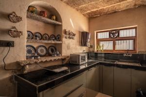 a kitchen with a sink and a microwave at Jorawar House in Būndi