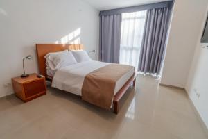 Postel nebo postele na pokoji v ubytování Suite House Juanambu