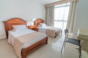 Postel nebo postele na pokoji v ubytování Suite House Juanambu
