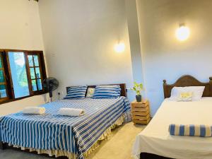 Postel nebo postele na pokoji v ubytování Unakuruwa Ravenala Homestay