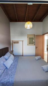 a bedroom with a large bed with two pillows on it at Luna Grande in Archangelos