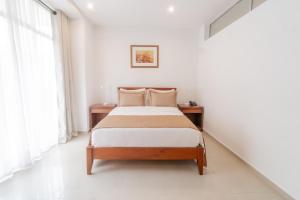 Postel nebo postele na pokoji v ubytování Suite House Juanambu