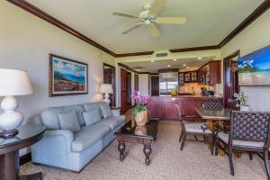 a living room with a couch and a table at Waipouli Beach Resort H301 in Wailua