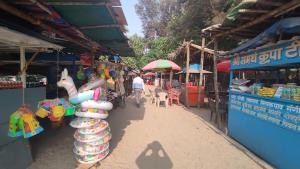 a market with a person walking down a street at OTP holiday homes in Kīhīm +43 photos