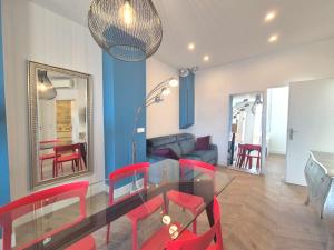 a dining room with a glass table and red chairs at Luxury 3 bed 2 bath flat Cannes Croisette in Cannes
