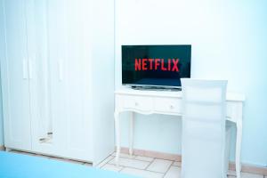 a television sitting on a white table in a room at PEPEROSA Rooms and Events - Peaceful countryside escape with pool, private parking, just minutes from the sea, Anzio and Nettuno in Nettuno