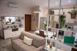 a living room with a couch and a kitchen at Casa Lucrezia - alla Torre in Viterbo