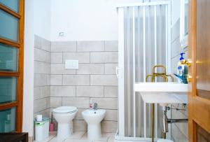 a bathroom with a toilet and a sink at PEPEROSA Rooms and Events - Peaceful countryside escape with pool, private parking, just minutes from the sea, Anzio and Nettuno in Nettuno +24 photos