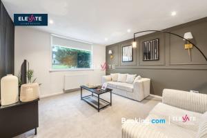 a living room with a couch and a table at Premium Offers, Last-Minute Escapes, 3 Bedroom House, Free Parking, Sleeps Up to 5, Private Garden, Elevate Living Estates Short Lets & Serviced Apartments Northampton in Spinney Hill