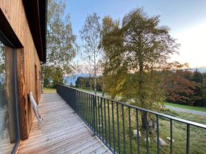 a balcony of a house with a view of a tree at Hillside Retreat in Fresach