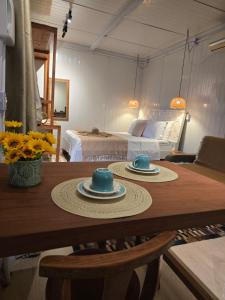 a room with a table with two hats on it at Equus - Refúgio da Ilha in Florianópolis