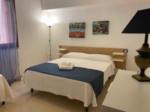 a bedroom with two beds and a table with a lamp at Le Case di Palma - Villa Maria in Custonaci +64 photos