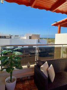 a balcony with a couch and a potted plant at Mini villa 1 Al hoceima in Al Hoceïma