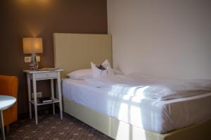 Postel nebo postele na pokoji v ubytování Hotel Leicht