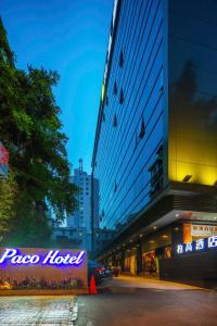 a building with aokedoked sign on the side of a street at Paco Hotel Tаojin Metro Guangzhou-Free Shuttle Bus For Canton Fair in Guangzhou